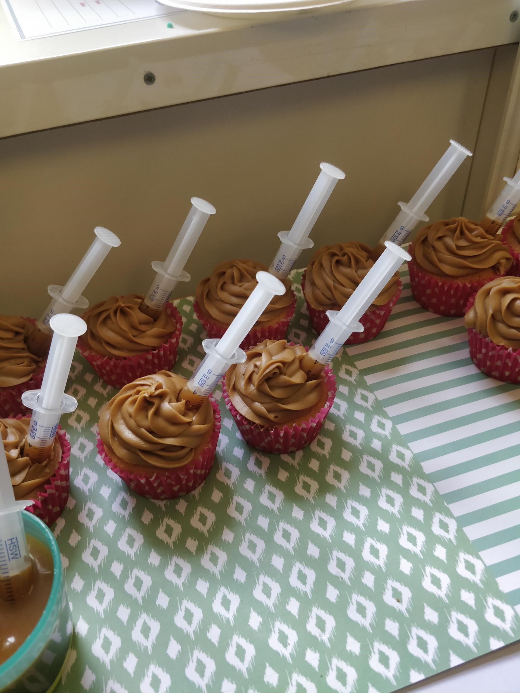 Apple and toffee cupcakes with syringes of toffee sauce